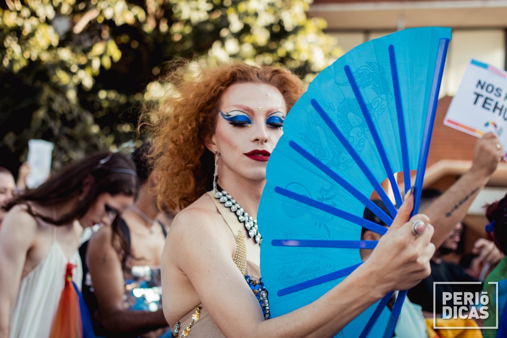 Mujer trans ondea un abanico en la Marcha del Orgullo de Santa Fe 2022 